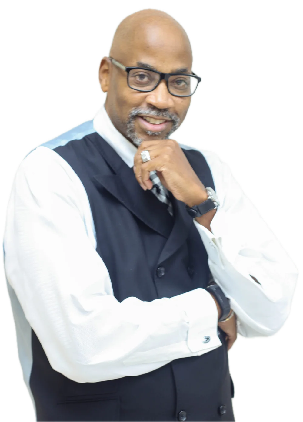John C. Gilbert, MBA, smiling with his hand to his chin, in a white shirt and navy vest